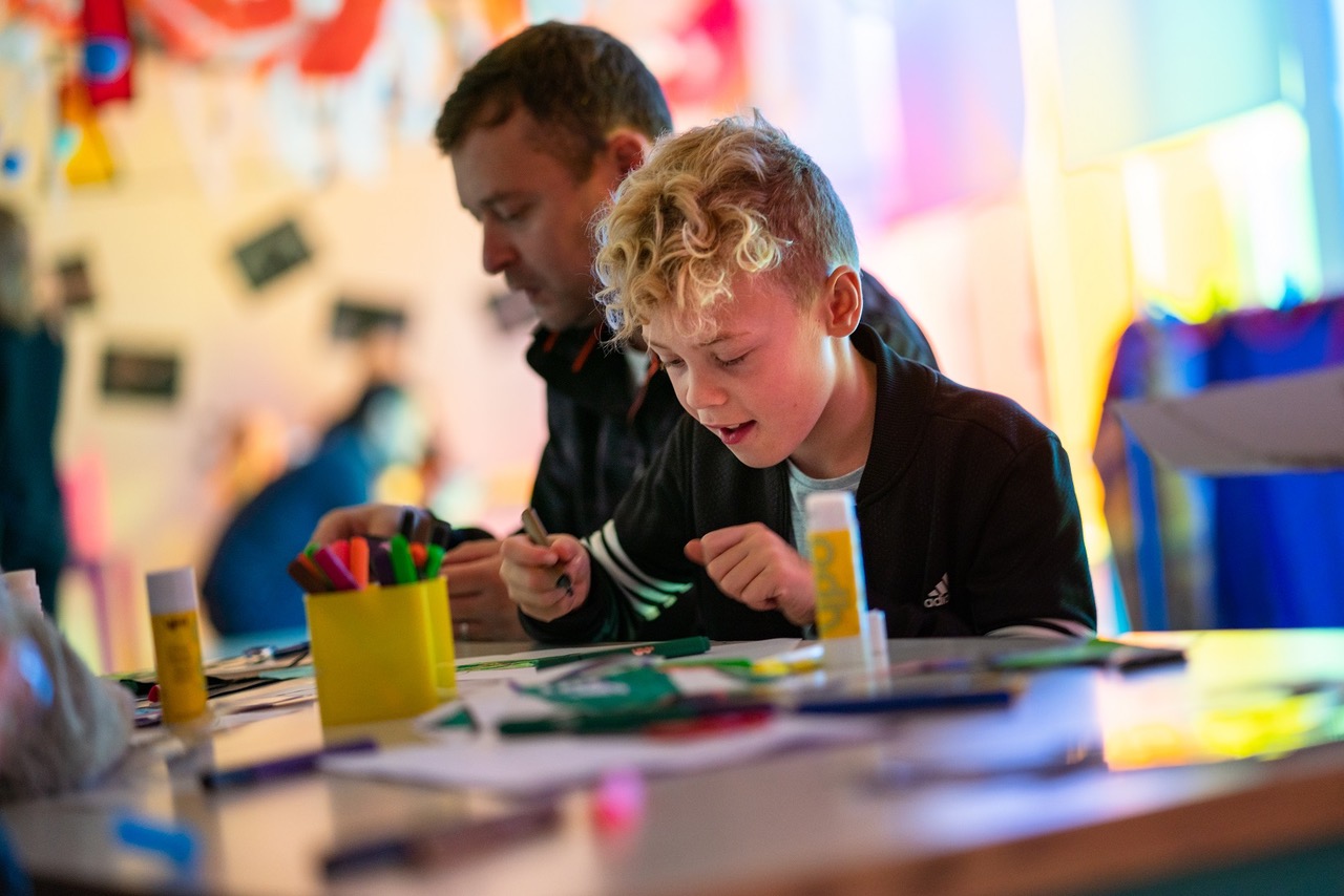 An adult and child at a craft table