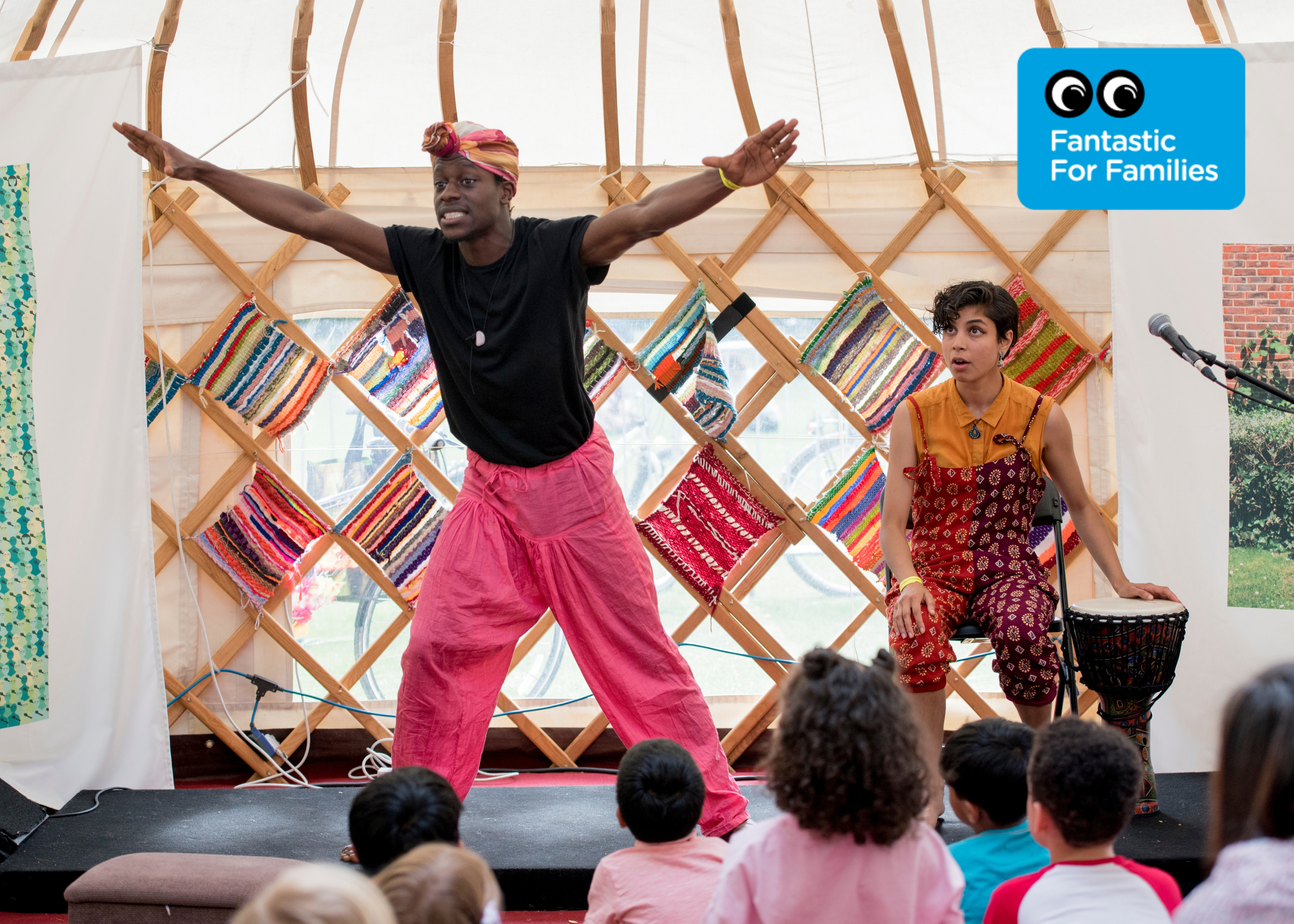 Performers at Walthamstow Garden Party playing to an audience of children