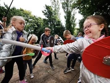 Children fighting with toy swords and shields
