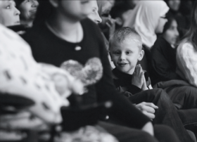 Black and white photo of a family audience